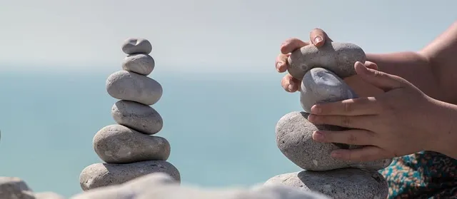 A girl is raising a pile of rocks