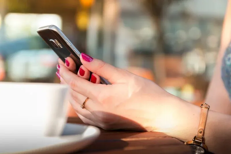 A woman is holding her phone.