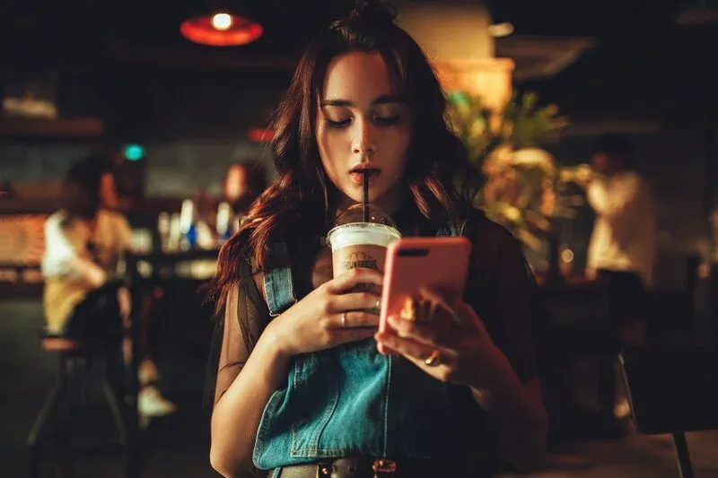 A woman is watching her phone.