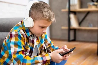 /boy-with-headphones-using-smartphone