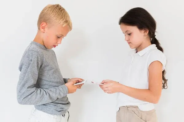 Little children are using their new cell phones.