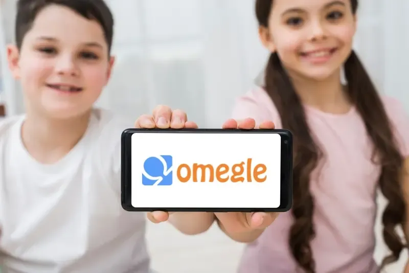 Two kids are showing off the Omegle software on their cell phones.