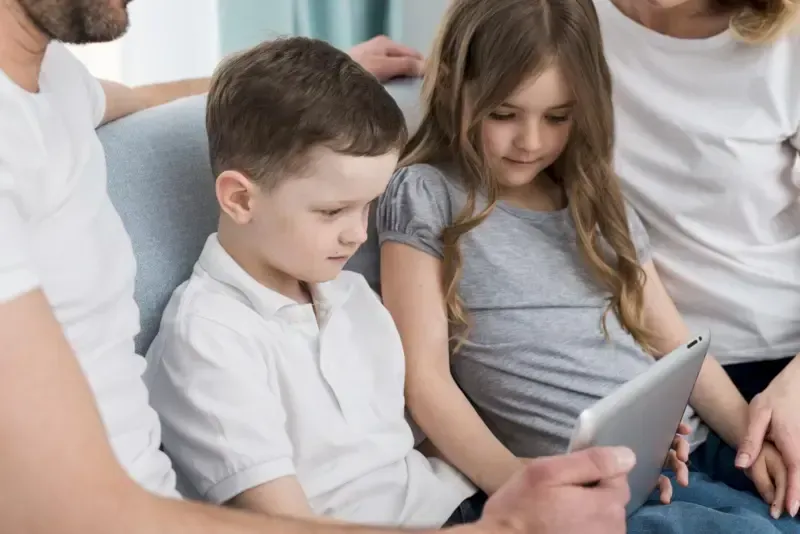 A family is watching iPad.